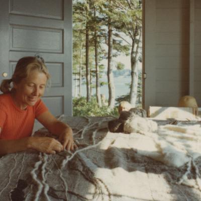 Nancy working at a large table in her art studio