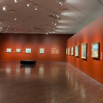 Gallery view of paintings hanging along the walls