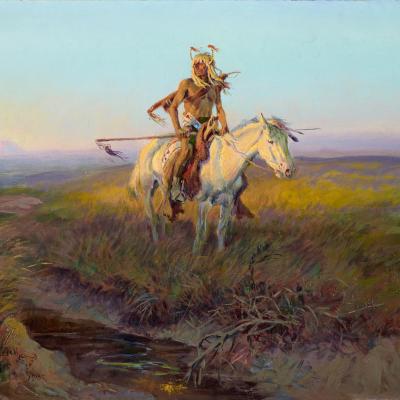 Native American man riding a white horse in the middle of the Western plains
