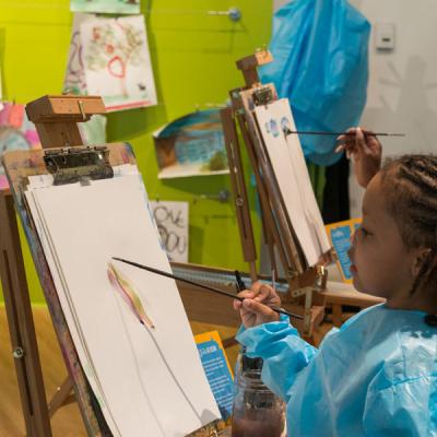 a girl and a woman painting at easels in the Paint Studio