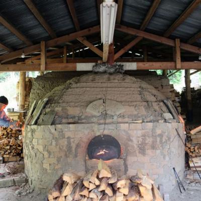 two men firing kiln