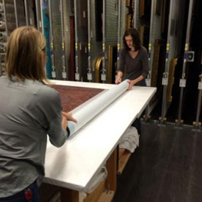 Textile storage assistants roll textiles