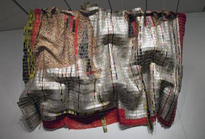 Metal is threaded together to create the appearance of fabric, mainly silver, red and yellow colors