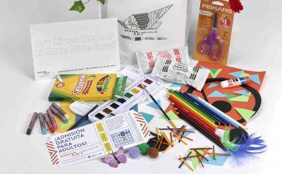 Creativity Kits made by the Denver Art Museum which includes crayons, paints, colored pencils, scissors, construction paper, and other crafting supplies