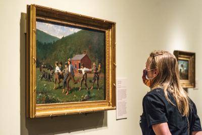Visitor looking at art at the Denver Art Museum