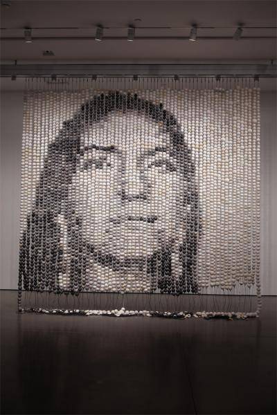 Large beaded installation that shows the image of a face