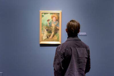 Man looking at impressionist painting