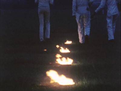 Performers walking away from fire