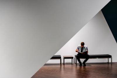 Man sitting and reading on a bench in the galleries
