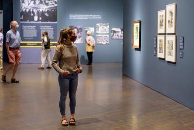 Masked woman in gallery