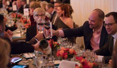 Guests clinking their wine glasses at an Uncorked event