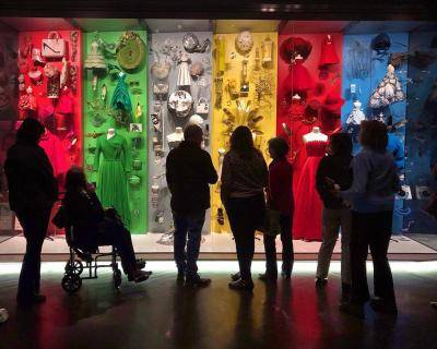 Large group of museum visitors, with one visitor in a wheelchair