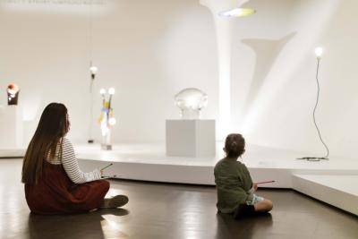 Family looking drawing while looking at art at the Denver Art Museum