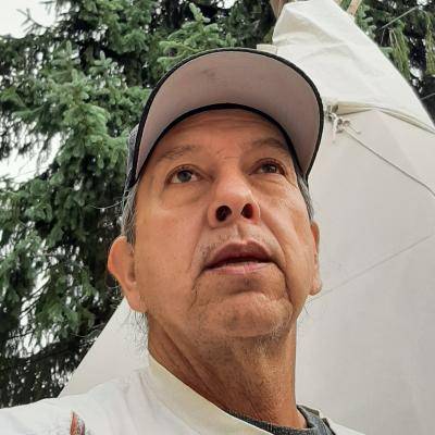 Sid Whiting in front of a tipi