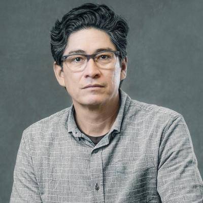 Steven Yazzie in a gray shirt in front of a gray background