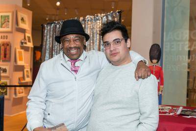 Two men, Charles and Aric, smiling for the camera