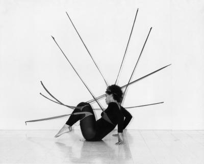 A woman striking a dancer's pose on the ground