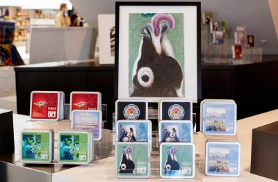 boxes of puzzles for sale in the museum shop with a large photo of a Georgia O'Keeffee painting of a cow with its tongue out