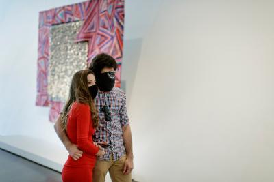 Young couple in masks enjoying the galleries
