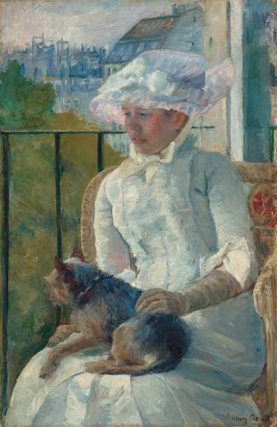 Young girl sitting at a window with her dog in her lap.