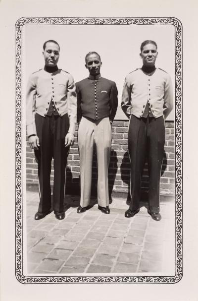 Three men in uniform on the roof of the Jayhawk hotel