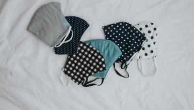 6 cloth face masks on a white cloth