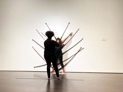 violinist and dancer in front of nylon sculpture