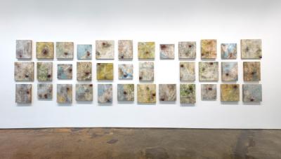 Credible by Sonya Kelliher-Combs (Inupiaq/ Athabascan), Installation of 32 panels - acrylic polymer, paper, human hair, and nylon thread on panel