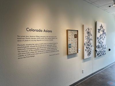Colorado Asians text and artworks on a gallery wall