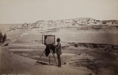 An old photograph of someone taking a photo in Pueblo Laguna, New Mexico.