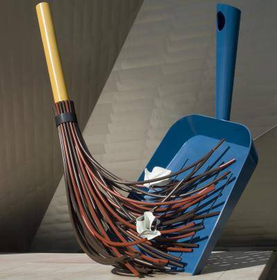 Large sculpture of a broom and dustpan