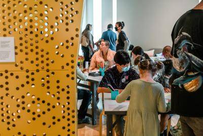 people at activity stations in The Thread Studio