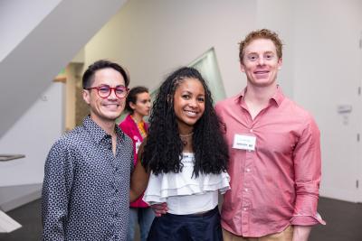 a woman and two men side by side in the atrium at the DAM
