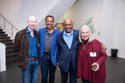 3 men and 1 woman side by side in the atrium at the DAM