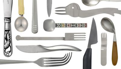 Repeating patterns of knives, forks, and spoons against a white background