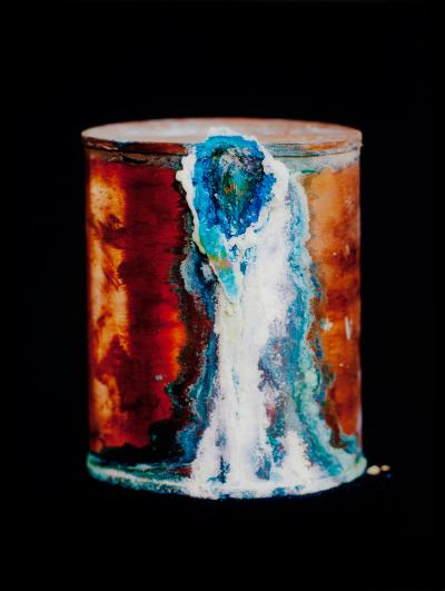 a copper urn with blue and white mineral encrustations