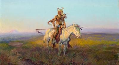 Lone Native American rider on a white horse on the plains