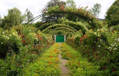 Monet’s Grand Allee (from the front porch, looking toward the front gate) with many different type of flowers