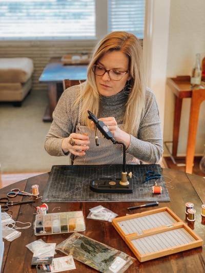 DAM staffer Katelyn Odenheimer making new fly patterns to tie for her next fishing trip.