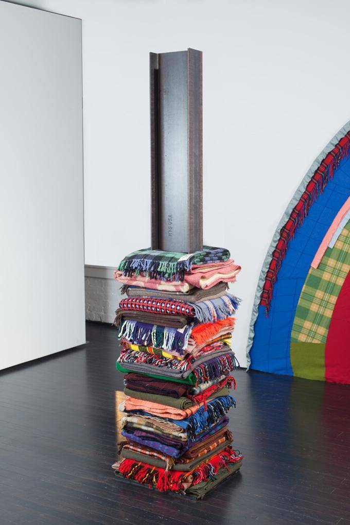 Colorful patterned blankets stacked like a tower