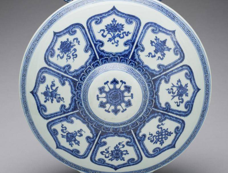 white and blue porcelain container called a moon flask