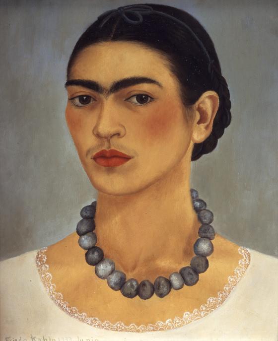 Painting of Kahlo in her mid-twenties with rosy cheeks and hair tied in a low braid. She wears a white blouse trimmed with lace and a large beaded necklace.