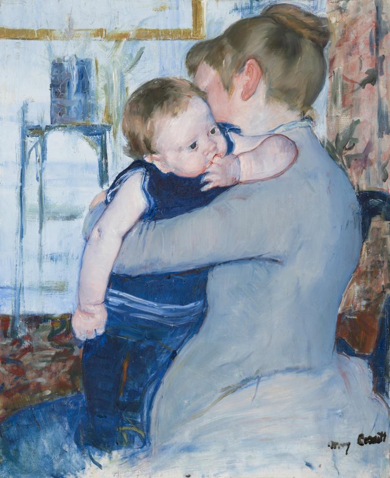 A woman facing to the side with her child wrapped in her arms.