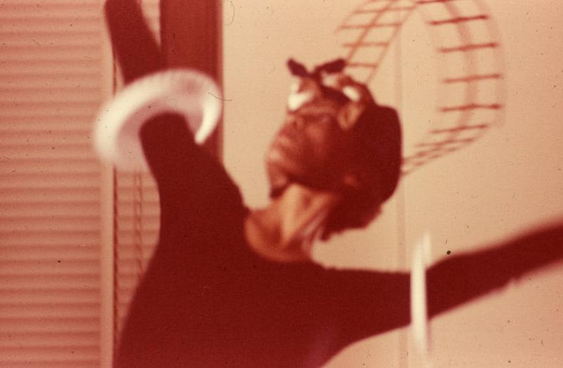 Digital slideshow featuring eight blurry photographs that document two female artists exploring movement with their bodies