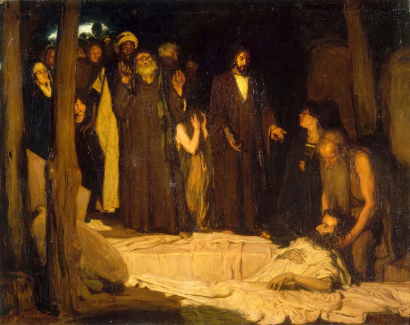 View of a group of men crowded around a man in repose.