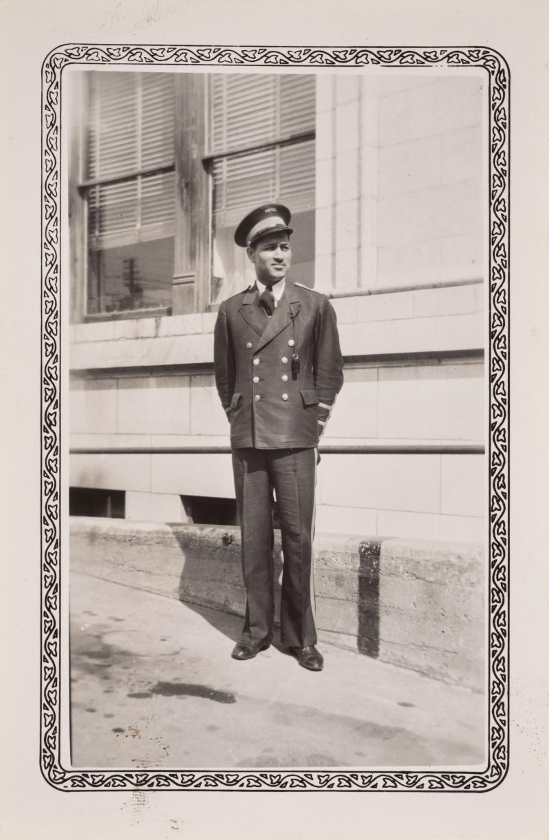 a man in a bell captain uniform outside the hotel
