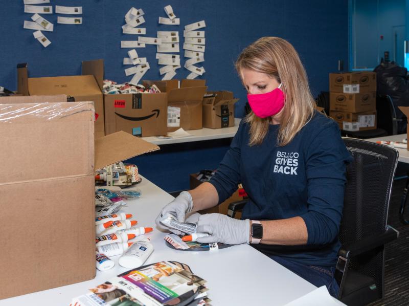 Female Bellco employee putting together art kits