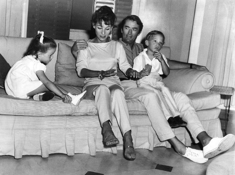 Black and white photograph of family on the couch.