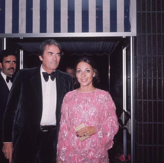 Color photo of Gregory on the left in suit and bowtie, and Véronique on the right in a sparkly, beaded, pastel pink, long sleeved dress.