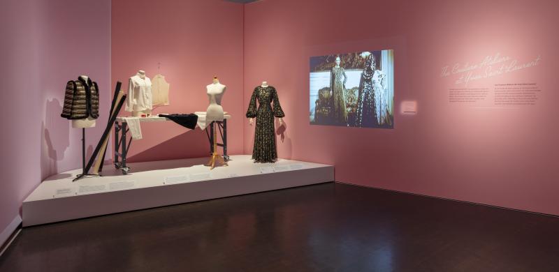 Photograph of installation that mimics the inside of a fashion designer’s workshop.